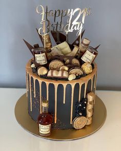 a birthday cake is decorated with chocolate, cookies and confective items for the 21st birthday