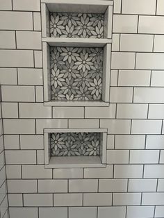 a white tiled bathroom with two square windows