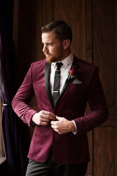 a man in a red suit and black tie