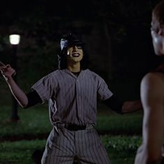 a baseball player with his face painted to look like it is holding a bat in one hand