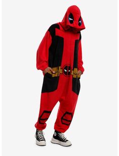 a man in a deadpool jumpsuit is standing with his hands on his hips