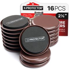 stack of brown and black x - protector pads on top of each other in front of a card