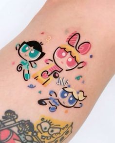 an arm with cartoon characters on it and confetti all over the top of it