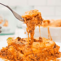 a piece of casserole is being lifted with a fork