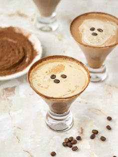 two glasses filled with coffee and topped with whipped cream