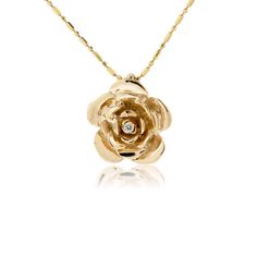 14K Gold .035ctw Diamond Rose Pendant Brilliant petals of 14K rose gold are accented with a single shimmering diamond which is prong set at the center of this golden rose. The timeless beauty of a rose is echoed in this rose and diamond pendant, designed and hand crafted by the amazing artists at Park City Jewelers. Your rose pendant will be created for you in your choice of 14K yellow gold, 14K white gold, or 14K rose gold. The chain is not included with this pendant. Chain is not included Prod Rose Pendant Gold, Gold Diamond Jewelry With Rose Design, Milestone Photos, Baby Milestone Photos, Amazing Artists, Gold Apple, Gold Pendant Jewelry, Flower Style, Rose Pendant