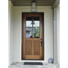 the front door is made of wood and has a lantern on it's side