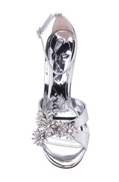 Crystal flowers and a mirror-shine finish kick up light in a sandal that's ready for wherever the night takes you. 4" heel Adjustable ankle strap with buckle closure; hidden elastic inset Synthetic upper and lining/leather sole Imported Holiday Evening Ankle Strap Sandals, Holiday Gala Sandals With Ankle Strap, Formal Holiday Ankle Strap Sandals, Formal Ankle Strap Sandals For Holiday, Holiday Heels With Ankle And Heel Straps, Holiday Evening Sandals, Holiday Ankle Strap Sandals For Events, Holiday Event Sandals With Ankle Strap, Silver Sandals For Spring Events