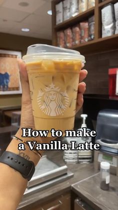 a person holding up a starbucks cup with the words how to make a vanilla latte