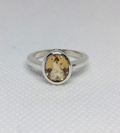 "All pieces are sent in a giftbox and placed in a netted, organza bag, ready for gift giving! 9x7mm Genuine Citrine rings set in Sterling Silver. 3.5 Grams approx. faceted These rings are handmade hand-set and on the rare occasion that they have a minor imperfection, you can always return for a full refund. No questions asked. Boho ring hippie ring birthstone ring The healing properties of CITRINE... The of Aries, Gemini, Leo and Libra can all see benefit from having, wearing or using the chakra Minimalist Topaz Gift Ring, Handmade Oval Topaz Ring For Gift, Yellow Topaz Birthstone Ring Gift, Amber Topaz Ring Certified For Gift, Amber Topaz Hallmarked Ring Gift, Citrine Rings, Gemini Leo, Hippie Ring, Hippie Rings