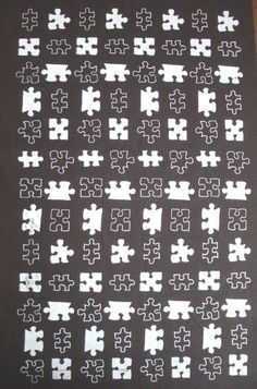 a black and white puzzle piece pattern on a tablecloth with the missing pieces cut out