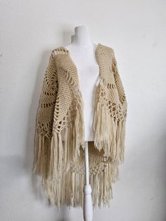 Fluffy, open knit Shawl with large spiral design and Fringe around entire bottom. Hand knit to perfection. Yarn is soft and fluffy, Fringe is perfect. No itchiness. Perfect shoulder wrap from the 1970s. Bohemian Open Knit Crochet Top One Size, One Size Bohemian Open Knit Crochet Top, Bohemian One-size Open Knit Crochet Top, Bohemian One Size Open Knit Crochet Top, Bohemian Beige Knit Cardigan, Bohemian Crochet Top In Knitted Yarn, Beige One-size Crochet Top, One Size Beige Crochet Top, Beige Bohemian Crochet Top