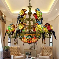 a chandelier hanging from the ceiling in a living room with birds on it