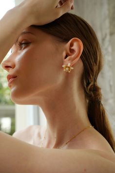 Evoke the essence of spring with the Magnolia Floral Stud Earrings, blooming with timeless elegance. Delicate magnolia blossoms crafted in intricate detail cradle lustrous pearls, creating a captivating floral motif. These earrings are the perfect accessory to elevate any outfit, whether it's a romantic date night or a casual brunch with friends. Pair them with a floral sundress and sandals for a fresh and feminine look, or with a tailored blazer and trousers for a sophisticated touch to your wo Elegant Wedding Earrings For Spring, Elegant Spring Wedding Earrings, Feminine Pearl White Earrings, Feminine Pearl White Bridal Earrings, Feminine Blossom Jewelry For Spring, Spring Wedding Jewelry With Petal Design, Dainty Spring Flower Earrings For Wedding, Dainty Flower Earrings For Spring Wedding, Elegant Blossom Flower Pendant Jewelry