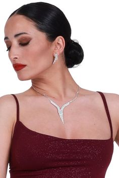 Tango performance jewelry set, White crystal rhinestone earrings, Silver sparkling wedding earrings and necklace, V shape strass necklace Isadora Tango Earrings & Necklace Set Enhance your Tango ensemble with the ideal combination of earrings and a necklace, designed to complement each other seamlessly. This jewelry set is versatile, pairing effortlessly with a wide range of outfits. Adorned with numerous rhinestones, you'll shine both on the dance floor and beyond. Pair with your favorite conDi Diamond White Jewelry Sets For Party, Bling Jewelry Sets For Wedding, Party Jewelry Sets With Rhinestones And Cubic Zirconia, Dazzling Crystal Sparkling Jewelry Sets, Sparkling Crystal Jewelry Sets, Diamond White Crystal Bridal Necklace For Party, Diamond White Cubic Zirconia Jewelry Sets For Evening, Dangle Rhinestone Necklace For Party, Party Dangle Rhinestone Necklace