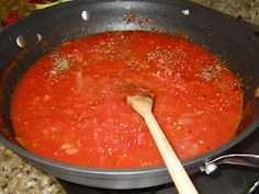 tomato sauce in a pan with a wooden spoon