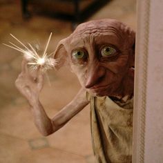 an old man holding a sparkler in his hand