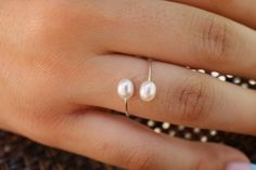 This is the cutest dainty oval pearl ring. They are amazing and trendy for any time of the year! Ring is adjustable to fit most sizes. Item comes exactly as shown in photos, please reference them for best representation of condition. It is my best interest to design long lasting beautiful pieces of jewelry for you that you will be proud to wear for many years! I design all my jewelry with care and passion. Thank you for browsing through my shop! Any questions about my designs or comments, please Oval Pearl Ring, Adjustable Oval Pearl Ring For Wedding, Year Ring, Minimalistic Ring, Tiny Rings, About Me Questions, Ring Oval, Minimalist Rings, Ring Silver