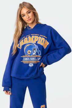 Get the oversized look with this champion graphic hoodie. This cozy drop shoulder sweatshirt is constructed from a soft flock fabric and features ribbed cuffed sleeves to lock in the warmth. Luxury Sports Sweatshirt, Luxury Oversize Hoodie Sweatshirt, Cheap Graphic Print Sweatshirt For Sports Season, Blue Sweatshirt With Text Print, Luxury Trendy Sweatshirt For Streetwear, Cheap Sports Sweatshirt With Screen Print, Luxury Letter Print Sweatshirt For Streetwear, Luxury Oversized Sweatshirt With Logo Detail, Cheap Oversized Logo Print Sweatshirt