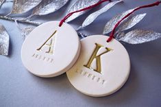 two personalized christmas ornaments with the letter k on them