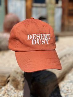 Unisex Dad Hat with Desert Dust logo embroidered on front panel. Adjustable strap in the back. Color: Rust Urban Dad Hat With Embroidered Logo, Retro Cotton Dad Hat With Embroidered Logo, Urban Style Six-panel Dad Hat With Embroidered Logo, 5-panel Outdoor Hat With Embroidered Logo, Outdoor Six-panel Dad Hat With Embroidered Logo, Logo Embroidered, Dad Hats, Adjustable Straps, Hats