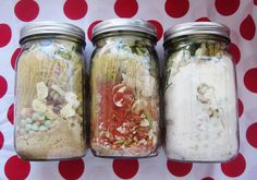 three jars filled with different types of food