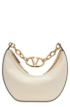 A gleaming chain centered with a VLOGO insignia spans the top of this hobo crafted from calfskin leather in a perfectly slouchy silhouette. Top zip closure Shoulder strap Leather lining Leather Made in Italy Designer Handbags White Valentino Bag, Valentino Bag, Bag With Chain, Luxury Purses, Valentino Bags, Bag Luxury, Leather Hobo Bag, The Saint, Chain Bag