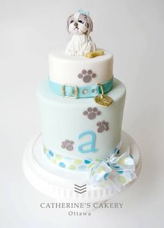 a cake with a dog sitting on top of it