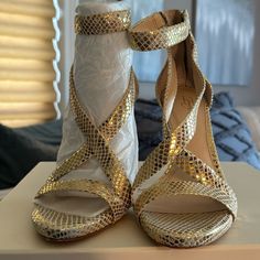 These Are From The Vince Camuto Imagine Line. They Are An Ivory/Soft Gold Marbled Snake Fabric. They Have A Beautiful Heel With An Ankle Strap They Are Stunning Shoe. These Are A Size 6 Never Worn. Gold High Heel Sandals For Spring, Gold Round Toe Sandals For Night Out, Gold Sandals With Wrapped Heel, Fitted Gold Sandals With Block Heel, Fitted Gold Sandals With Heel Strap, Fitted Gold Sandals With Wrapped Heel, Gold Closed Toe Heels For Spring, Gold Ankle Strap Heels In Synthetic Material, Gold Ankle Strap Heels With Synthetic Material