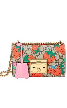 Padlock GG Strawberry Small Shoulder Bag. This shoulder bag from Gucci features a push lock closureSliding chain strap that can be as shoulder strap or can be as a top handleBeige/ebony GG Supreme canvas with Gucci Strawberry print.Camel microfiber lining with a suede like finishLight pink leather trim;1 main interior compartment with a slip pocketExterior pocket at the rearShiny gold-toned hardware; Key with leather holderExterior pocket;Lock closure;Size: W 8"/20 cm x H 5"/13 cm x D 3"/7 cmMade in Italy; Gucci Strawberry, Gucci Padlock, Handbags Gucci, Tas Bahu, Strawberry Print, Burberry Handbags, Gucci Handbags, Gucci Bags, Small Shoulder Bag