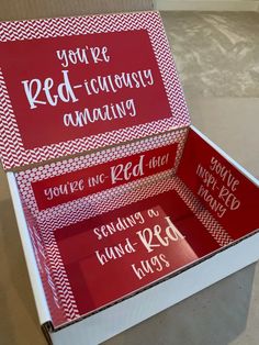 two red and white boxes with writing on the inside one says you're red - icingy amazing