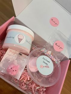 an open pink box containing ice cream and other items