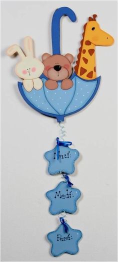 a baby's crib mobile with a giraffe, teddy bear and other animals hanging from it