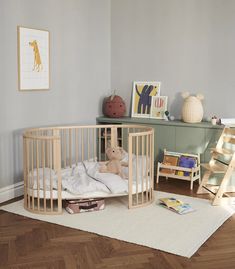 a baby's room with a crib and toys