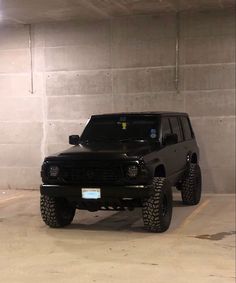 a black suv parked in a parking garage