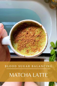 a person holding a cup of matcha latte in front of a sink with the words blood sugar balancing