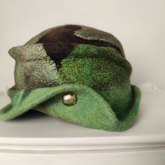 This cloche hat is made by using the best quality materials available such as the softest 18 micron merino wool, Mulberry silk fibers, Tussah silk fibers, handloom Uzbek silk fabric. This hat is professionally shaped, it will keep it's shape. Please store in the box it arrives in. The hat is flexible, the sizes given may fit 1 cms - 0,5 inches plus or minus. Size 56 cms 22 inches The hats are made in different styles and shapes. From elegant with roses to boho with  fringes, you can find your st Adjustable Brimmed Wool Cloche Hat, Adjustable Wool Brimmed Cloche Hat, Adjustable Wool Cloche Felt Hat, Fur Felt Cloche Hat For Winter, Winter Mini Hats With Short Brim In Green, Green Mini Hats With Short Brim For Winter, Green Mini Hat With Short Brim For Winter, Green Wool Hat For Fall, Green Winter Mini Hats With Short Brim