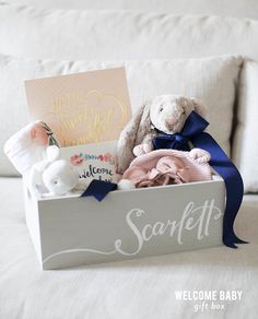 a gift box filled with stuffed animals and greeting cards for someone's special day