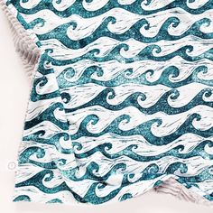 a blue and white blanket with waves on it