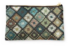 a small zipper bag with flowers and squares on the front in multicolored fabric