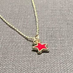 "A tiny enamel star charm hangs gently from a dainty gold filled chain...simple and elegant, perfect for layering. The star charm is available in red, yellow, white, light blue, dark blue, or light pink. The chain is 16\" with a 2\" extender. Very delicate and beautiful! 💙 If you prefer a magnetic clasp, check out the add-ons and upgrades section of our shop - it's available as an add-on to any bracelet and most necklaces, along with the option to upgrade your accent metal to solid 14k gold, ye Red Star-shaped Sterling Silver Jewelry, Red Star Shaped Sterling Silver Jewelry, Red Sterling Silver Star-shaped Jewelry, Enamel Star Charm Jewelry, Gold Star Charm Necklace Handmade, Handmade Gold Star Charm Necklaces, Handmade Gold Star Charm Necklace, Star-shaped Charm Necklaces For Gifts, Handmade Gold Charm Necklaces With Star Shape