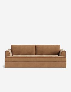 a brown couch sitting on top of a white floor