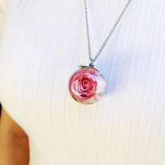 A pink rose necklace, made from a real flower bathed in resin, could be the most special gift for her mainly for these unique celebrations. This real rose necklace is part of my rosebud jewelry collection, a light pink collar that will perfectly fit your style. This rose resin necklace is truly an original and unique creation for every moment, whether those formal and elegant events or those more informal where you feel freer. Undoubtedly, the beauty of nature is engraved on us. That's why with Rose Flower Charm Necklace For Mother's Day, Rose Necklace With Flower Charm For Mother's Day, Personalized Rose Jewelry For Her, Personalized Rose Gold Jewelry For Her, Pink Flower Pendant Necklace For Valentine's Day, Delicate Rose Necklaces For Valentine's Day, Valentine's Day Pink Flower Pendant Necklace, Delicate Rose Necklace With Roses Detail, Rose Flower Pendant Necklace For Mother's Day