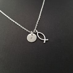 "Personalized Antique Silver Christian Fish Necklace! A detailed ichthys fish charm on a bright silver chain makes the perfect gift for you or a loved one. The Christian fish charm is made from zinc alloy and measures 20 mm by 8 mm. The chain is silver plated and measures 16\" or 18\" with a 1\" extender. You can also personalize your necklace with a .5\" silver plated disc stamped with the initial of your choice. To order your necklace WITHOUT a custom stamped initial disc, choose \"Charm & Christian Fish Necklace, Sterling Silver Fish-shaped Jewelry Gift, Sterling Silver Fish-shaped Jewelry As Gift, Fish-shaped Charms Necklace Gift, Chef Necklace, Fishing Bracelet, Christian Necklace, Fish Necklace, Etsy Personalized Gifts