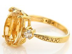 6.00ct oval Brazilian citrine with .50ctw round white topaz 18k yellow gold over sterling silver ring. Measures approximately 0.75"L x 0.50"W x 0.25"H. 0.06" shank. Not sizeable. Oval Gold White Topaz Ring, Gold Rings With White Topaz And Accent Stones, Yellow Gold Citrine Rings With Polished Finish, Formal Hallmarked Citrine Rings, Classic Yellow Hallmarked Topaz Ring, Yellow Citrine Hallmarked Rings, Luxury Hallmarked Citrine Rings, Citrine Jewelry, Yellow Gemstones