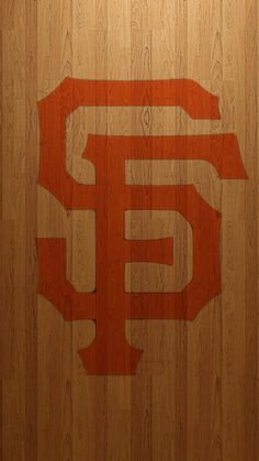 the san francisco giants logo is made out of wood on a wooden wall with planks