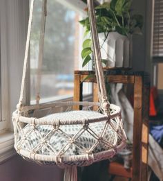 a white hanging basket next to a window