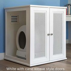 a white cabinet with an oval hole in the front and side doors on each side