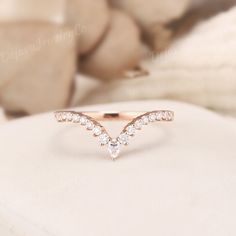 a diamond ring sitting on top of a white pillow