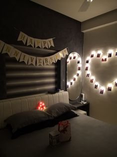 a bedroom decorated for new year's eve with lights on the headboard and decorations